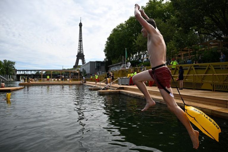 Joyful Parisians take a historic plunge into the Seine after 100 years